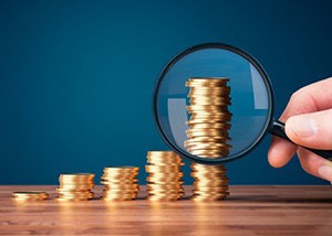 Stacks of coins examined with magnifying glass