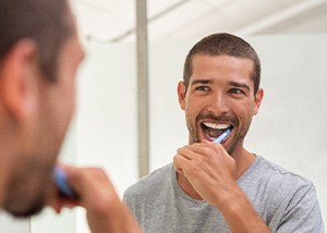 Brenham patient brushing gently after dental implant surgery