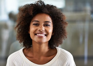 Smiling Brenham patient showing new dental implant tooth