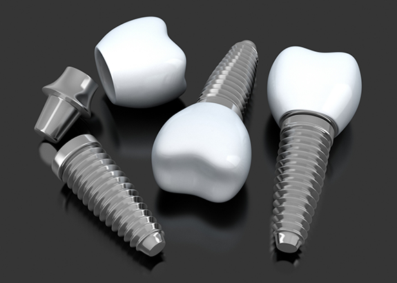 Three dental implants and three dental crowns against a gray background