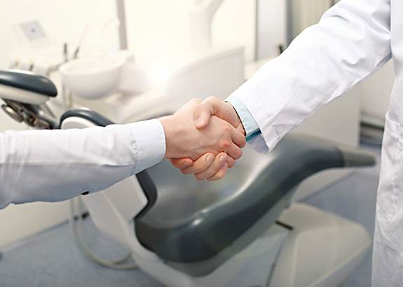 Person shaking hands with their dentist