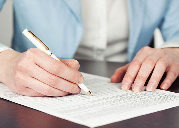 Person filling out a paper form