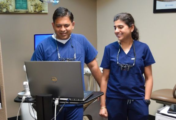 Two dentists looking at a computer together