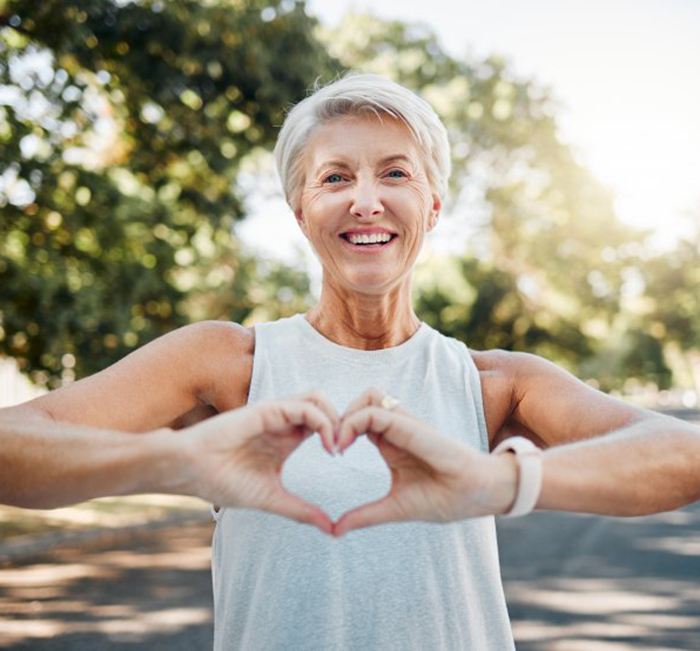 Lady makes shape of heart with her hands