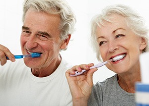 Senior couple brushing their teeth in bathroom