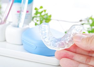 Hand holding a nightguard for teeth grinding