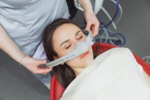 Woman receiving laughing gas for her dental visit